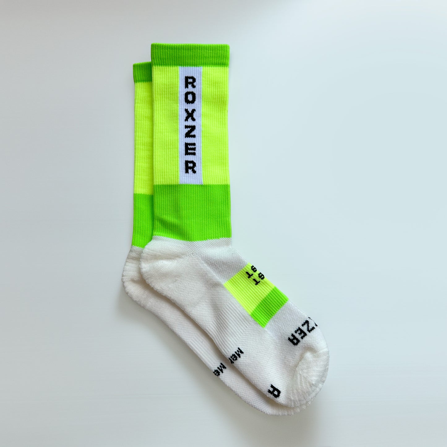 ROXZER Bold Block Merino HYROX performance sock, neon yellow & green, flatlay