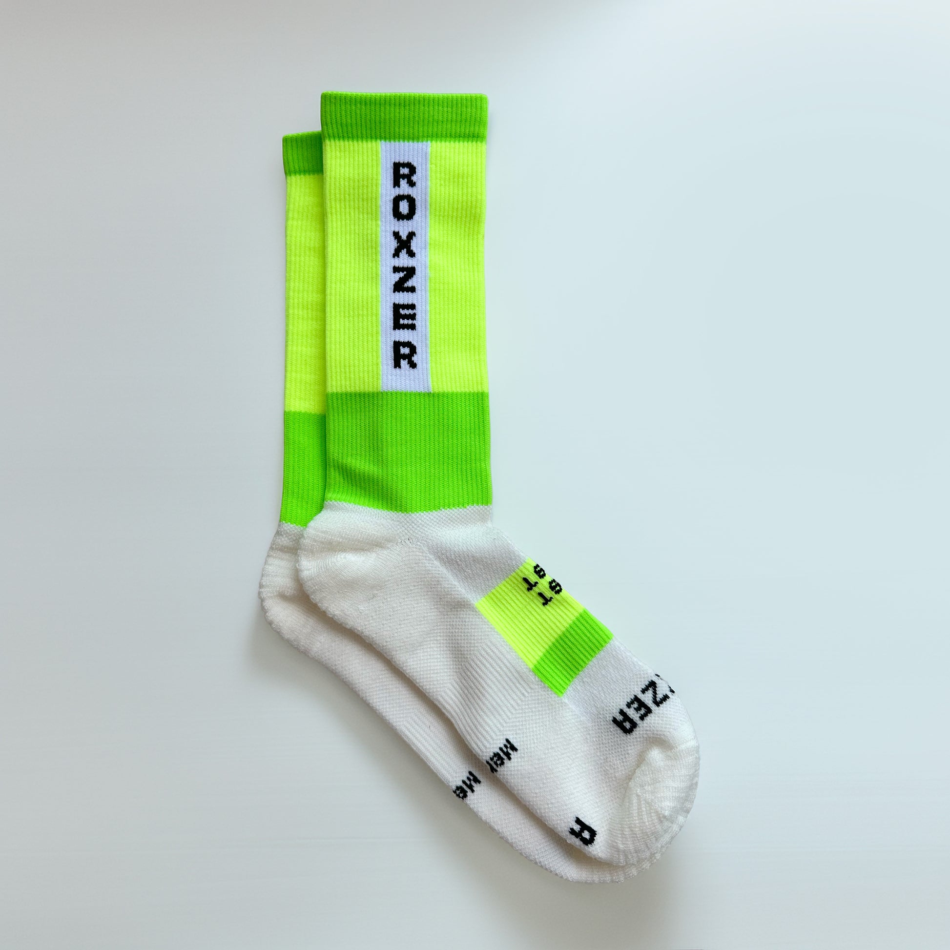 ROXZER Bold Block Merino HYROX performance sock, neon yellow & green, flatlay